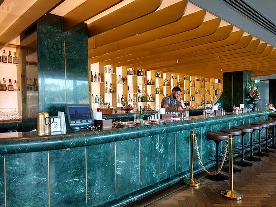 A marble cocktail bar with hard, sound-reflecting surfaces